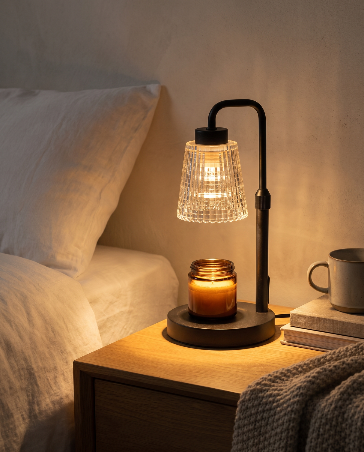 Ember candle warmer lamp glowing on a nightstand at night — lifestyle