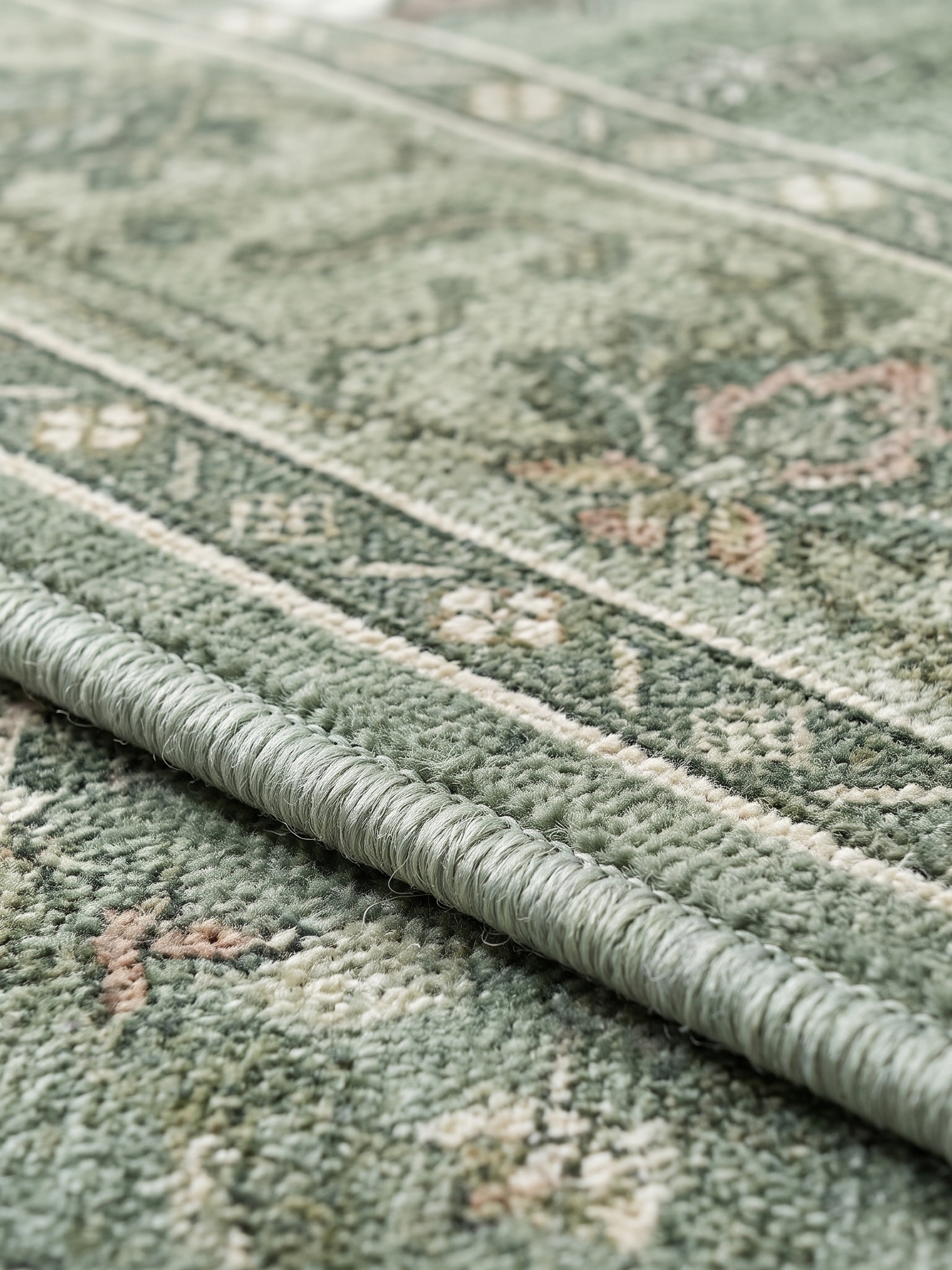 Juniper rug serged edge detail, close-up on white