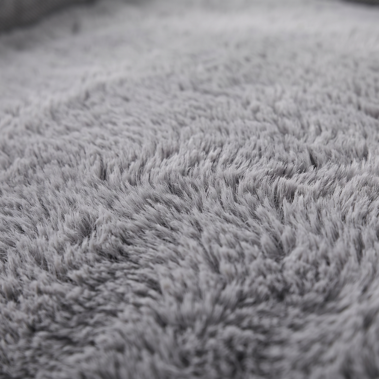 Cove dog bed plush faux-fur surface, close-up on white