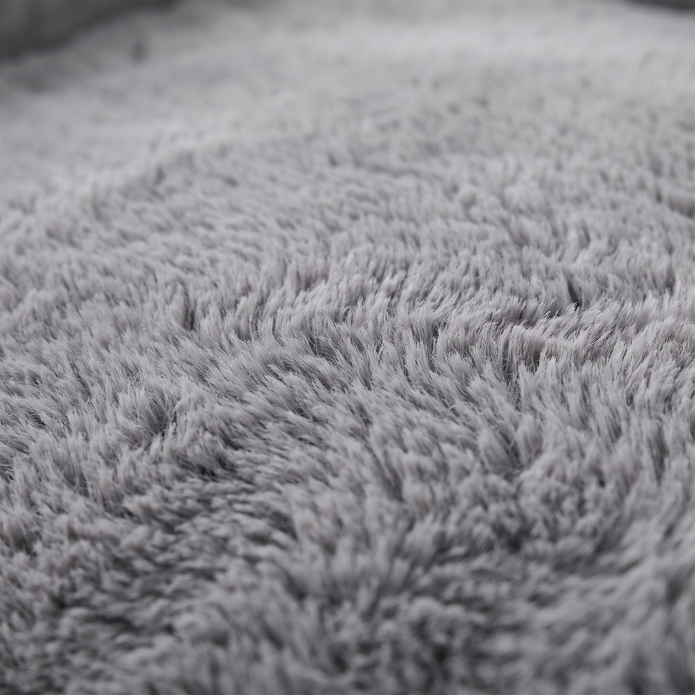 Cove dog bed plush faux-fur surface, close-up on white