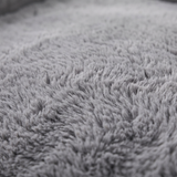 Cove dog bed plush faux-fur surface, close-up on white