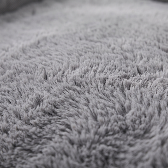 Cove dog bed plush faux-fur surface, close-up on white