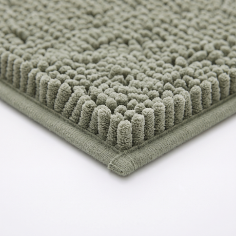 Pebble bath mat bound edge, close-up on white