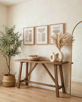 Cava travertine bowl styled among the collection on a console with vases, art, olive tree and mirror — buy the look