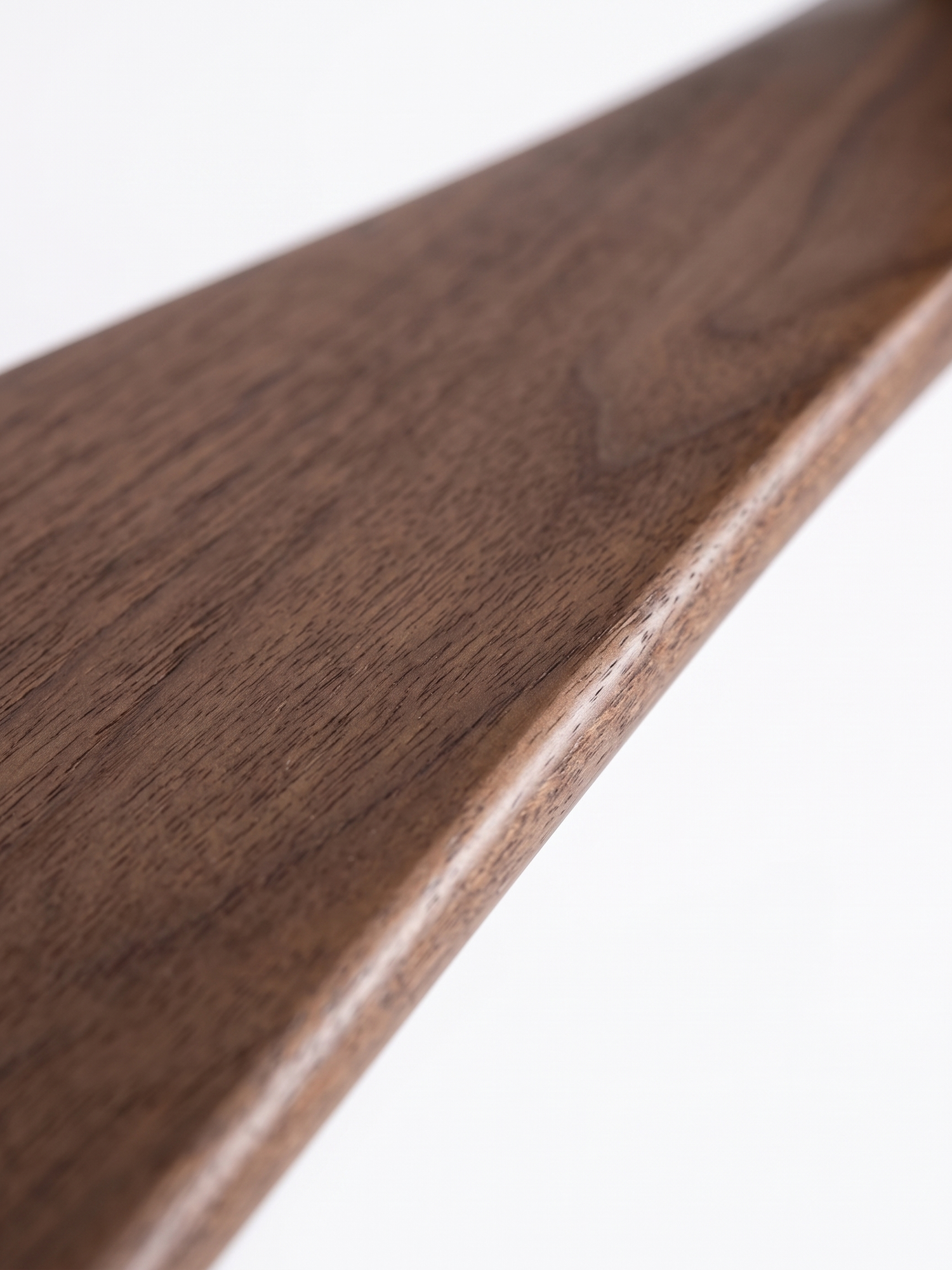 Walnut fan blade wood grain, close-up on white