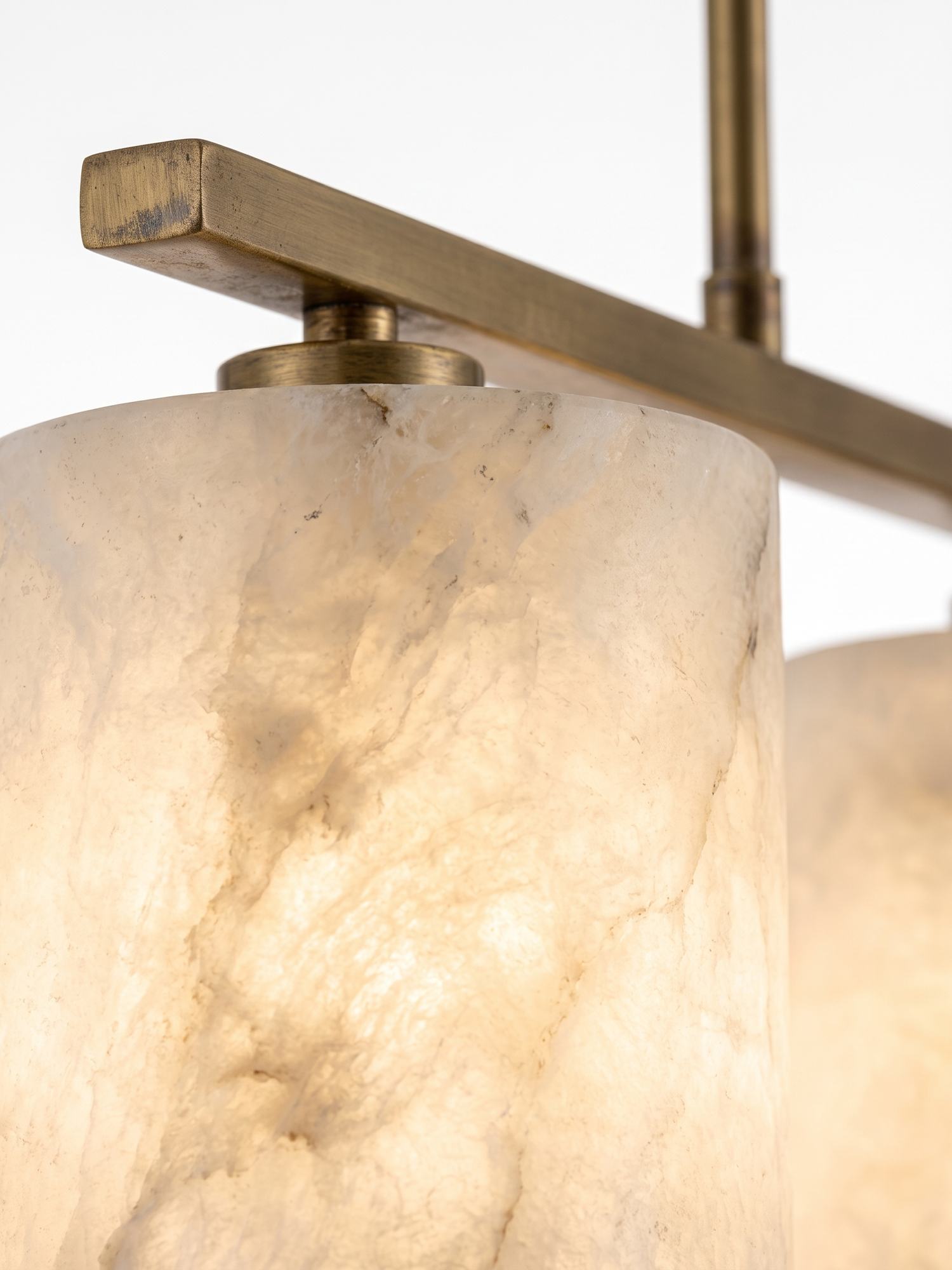 Alabaster shade glowing with natural veining, close-up on white