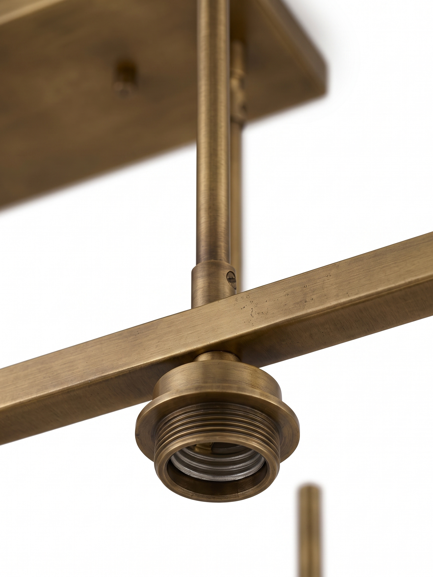 Aged-brass frame and canopy detail, close-up on white