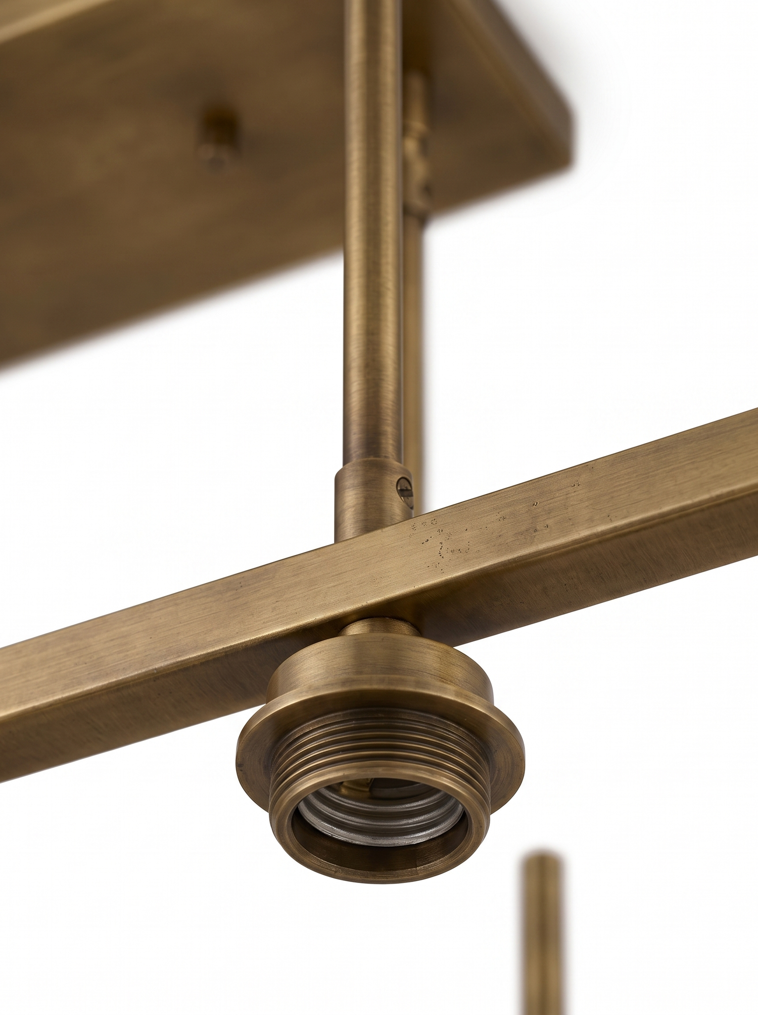 Aged-brass frame and canopy detail, close-up on white