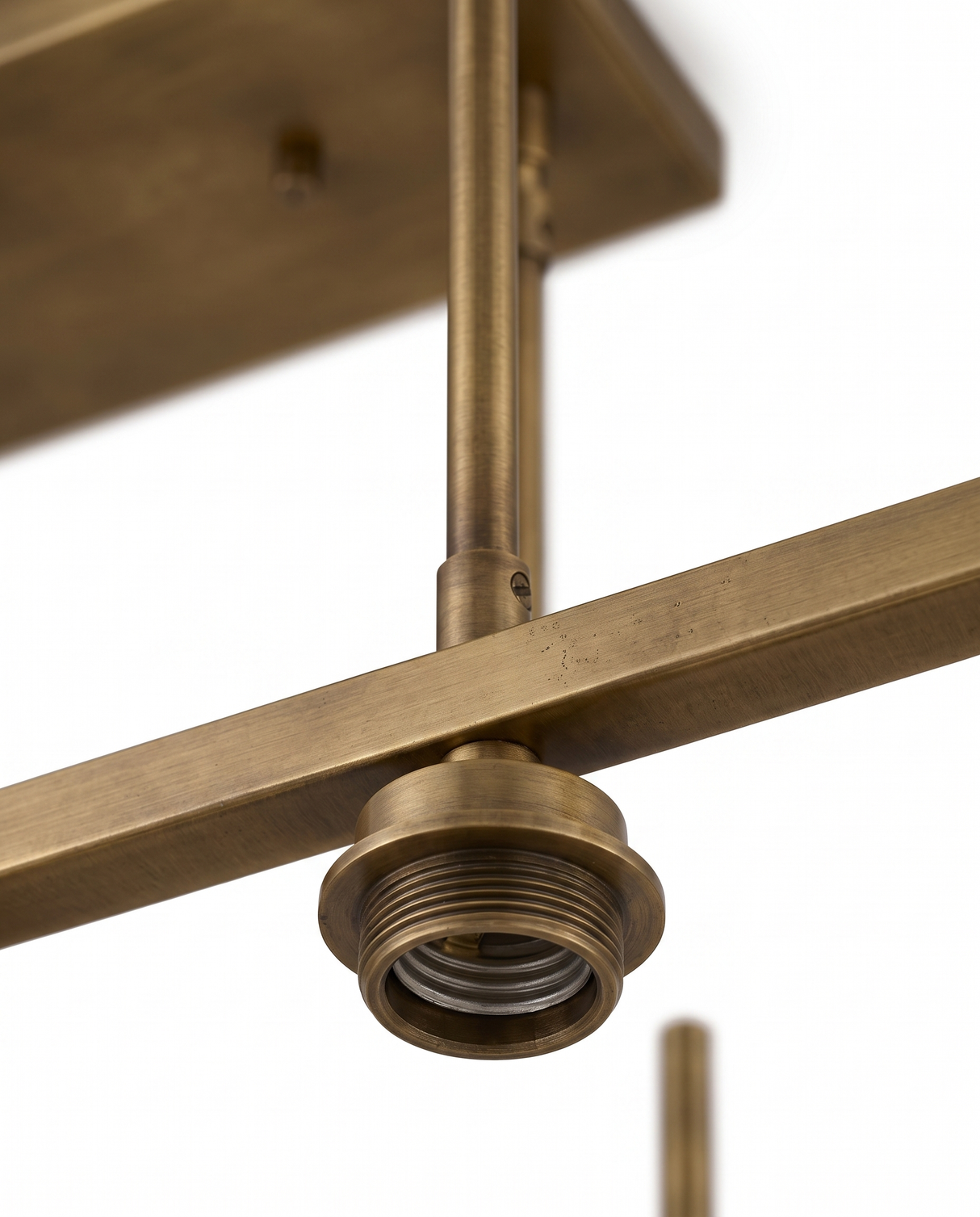 Aged-brass frame and canopy detail, close-up on white