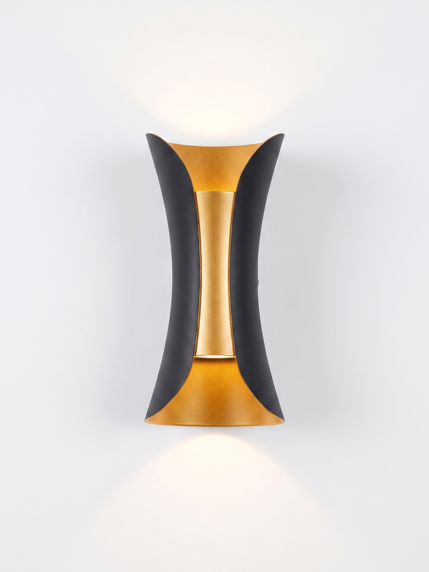 Marlow curved up/down wall sconce, black with gold reflector, studio on white