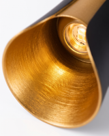 Brushed-gold reflector and warm LED, close-up on white