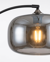 Dara arc floor lamp smoked-glass shade and warm bulb detail — studio white