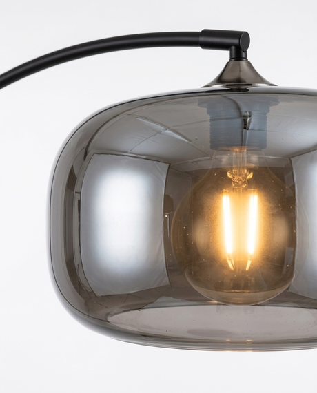 Dara arc floor lamp smoked-glass shade and warm bulb detail — studio white