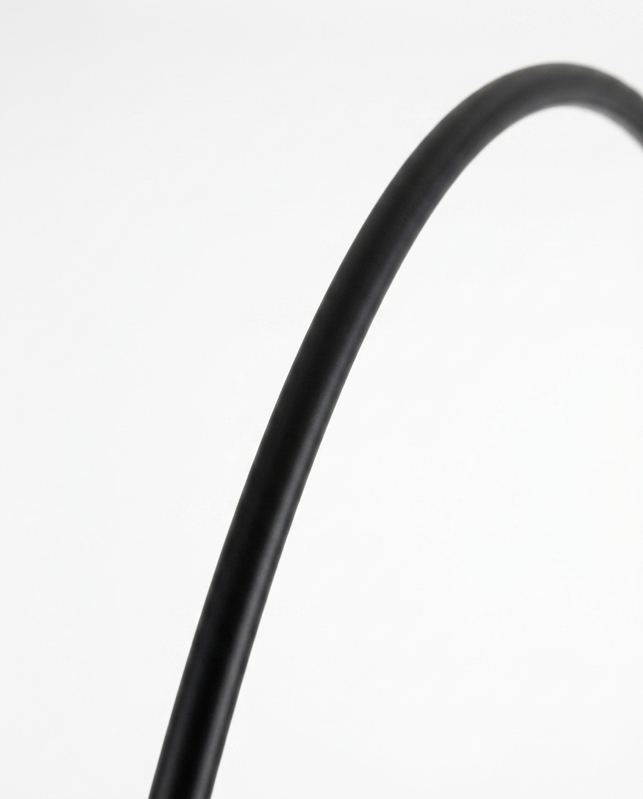 Dara arc lamp sweeping black arc rod detail — studio white