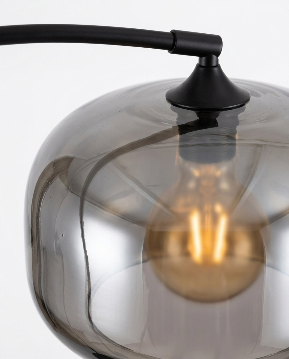 Dara arc lamp smoked-glass surface and cap junction detail — studio white