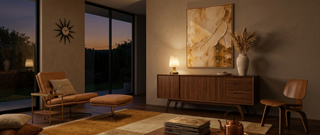 Linnea glowing on a walnut credenza in a mid-century modern living room lifestyle at dusk