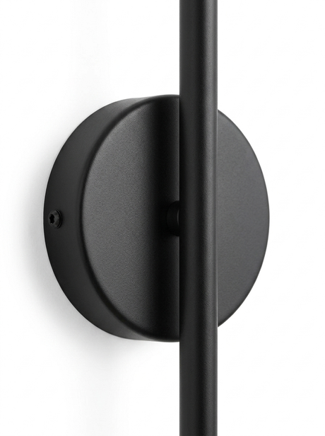 Close-up of the round matte-black wall-mount backplate