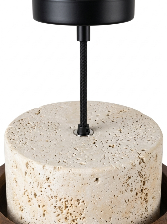 Close-up of the black cord and canopy meeting the top of the travertine shade