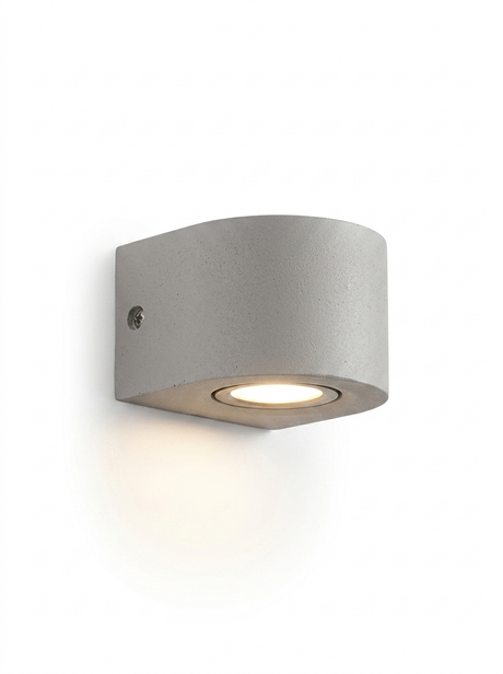 Ilse round curved concrete wall light in light concrete gray on a studio white background