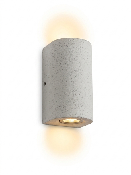 Ilse round tall cylinder concrete up-down wall light in light concrete gray on a studio white background