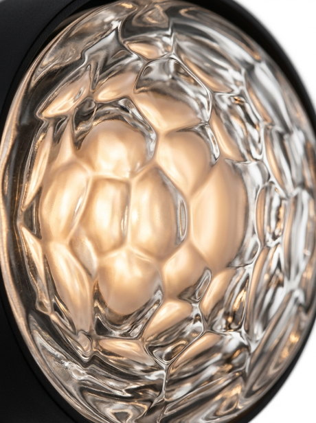 Macro of the faceted dimple glass lens with warm LED glow
