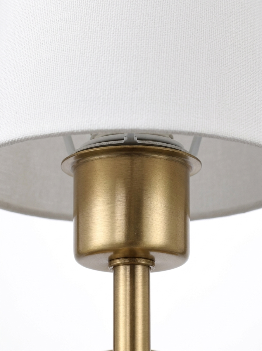 Macro of the brushed-brass socket cup where the empire shade rests