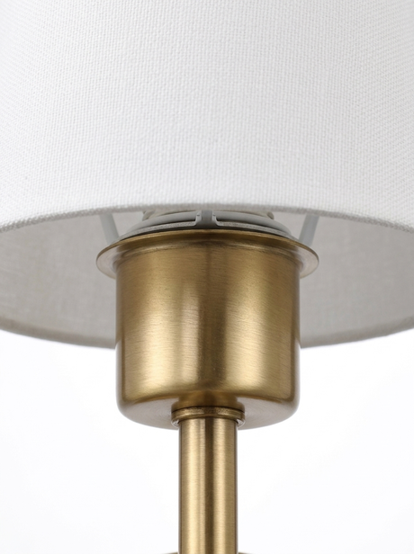 Macro of the brushed-brass socket cup where the empire shade rests
