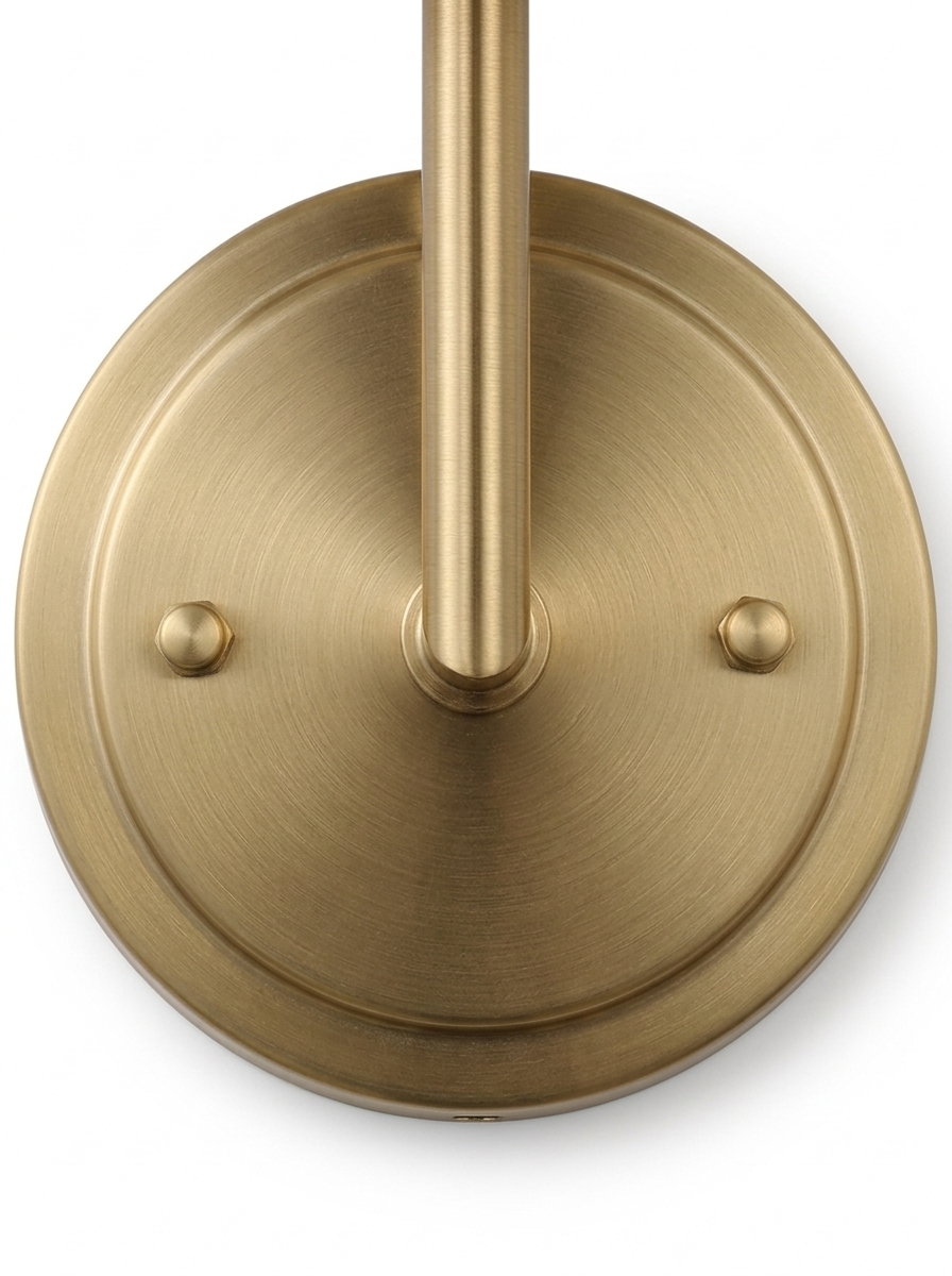 Head-on macro of the round brushed-brass wall backplate
