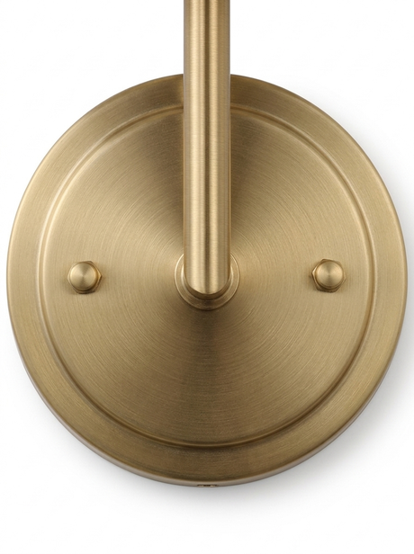 Head-on macro of the round brushed-brass wall backplate