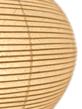 Macro of the ribbed Xuan rice-paper shade glowing warm