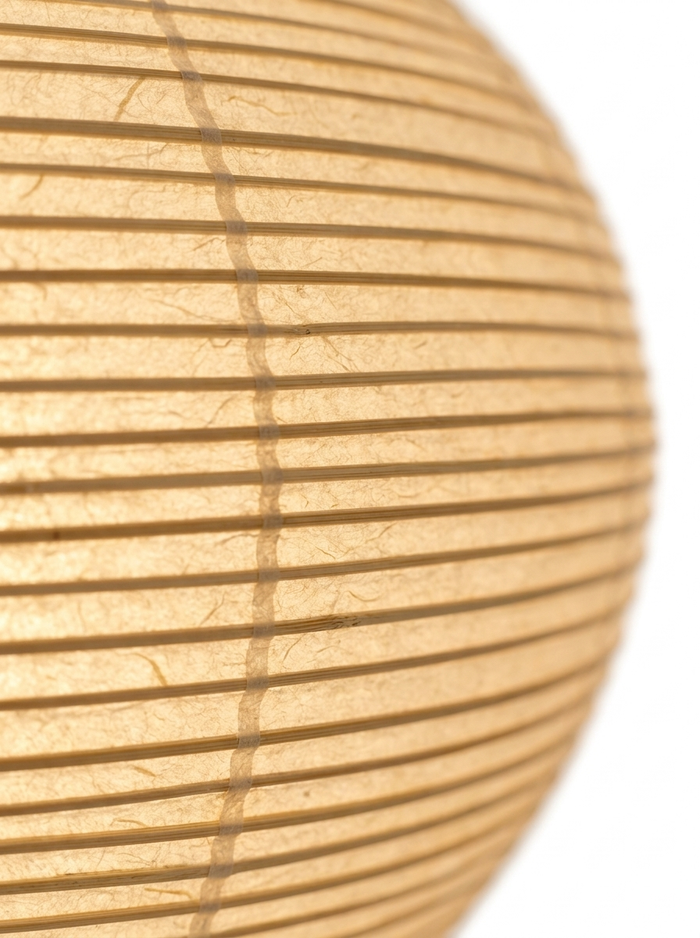 Macro of the ribbed Xuan rice-paper shade glowing warm