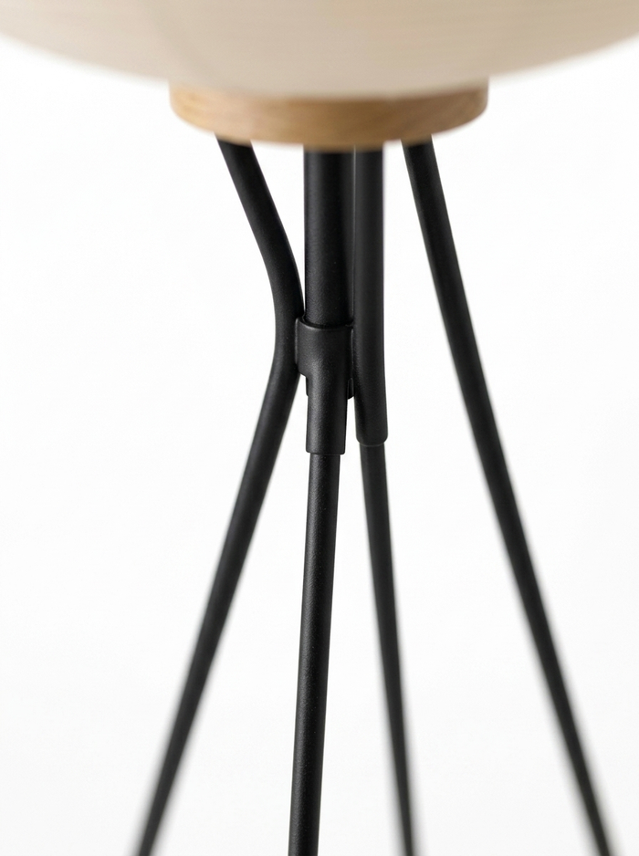 Close-up of the slim black steel tripod legs