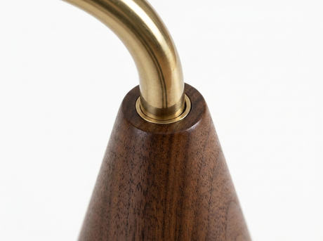 Cyra brass pole to walnut base join close-up