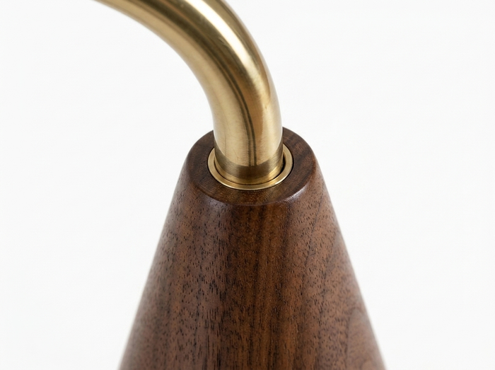 Cyra brass pole to walnut base join close-up