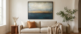 Havre seascape canvas framed above a linen sofa — lifestyle
