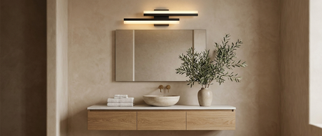 Orla asymmetric vanity light over a mirror in a warm modern bathroom — lifestyle
