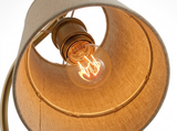 Elio glowing bulb inside the linen shade close-up