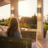 Ilse concrete up-down wall lights on a luxury golden-hour terrace with outdoor seating
