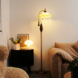 Ulla mushroom lamp glowing on a nightstand in a cozy reading corner