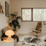 Ulla mushroom lamp on a side table in a mid-century living room