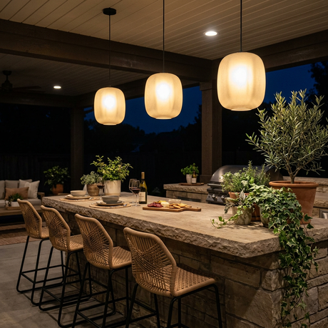 Runa outdoor pendants over a covered outdoor kitchen island bar at night — lifestyle