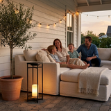 Ferro lantern on a covered farmhouse patio with family relaxing — lifestyle