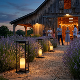 Ferro lanterns lining a lavender garden path to a barn gathering — lifestyle