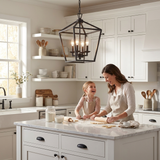 Kerri matte black pendant over a farmhouse kitchen island, mom and daughter baking — lifestyle