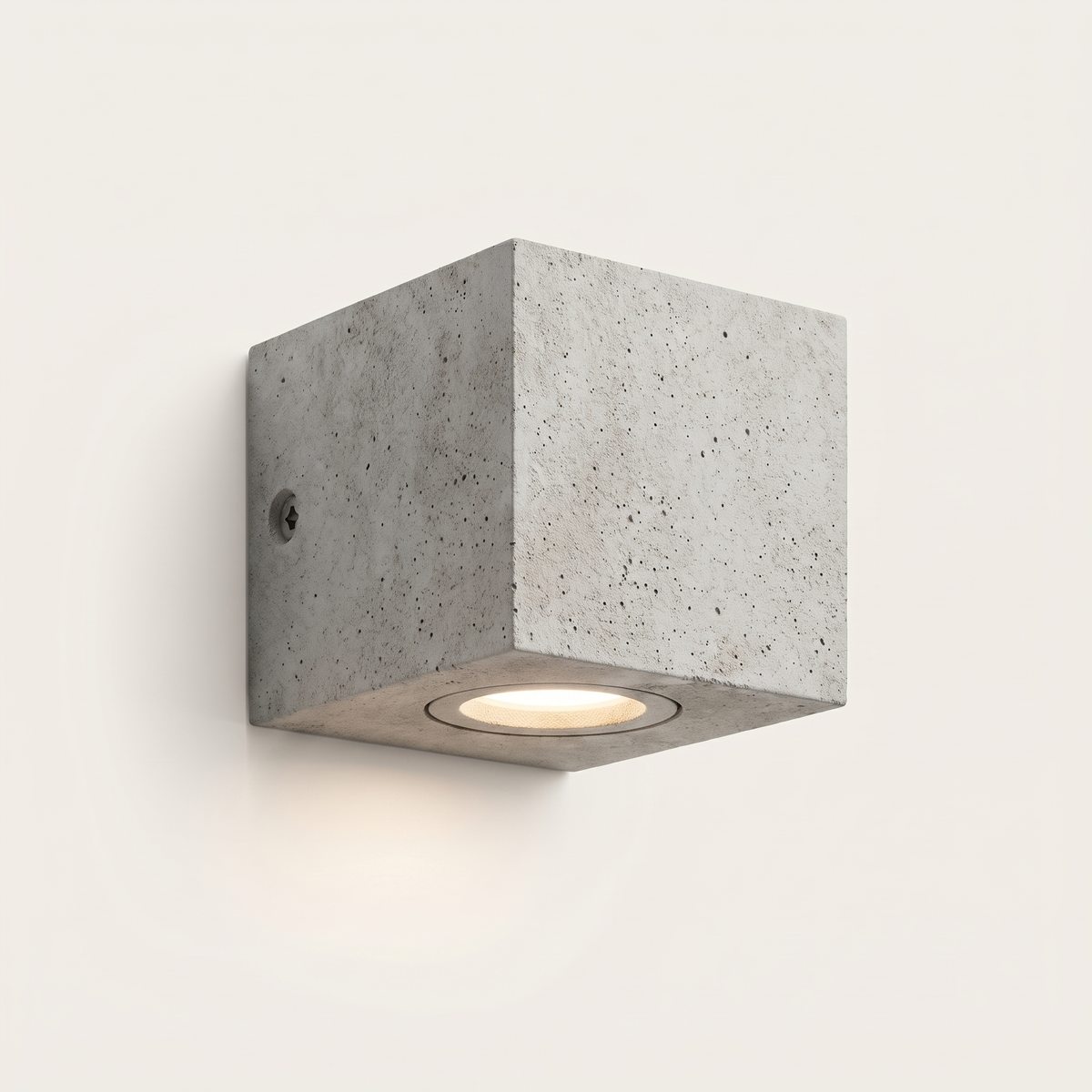 Ilse concrete outdoor wall light lit warm on a soft off-white studio background