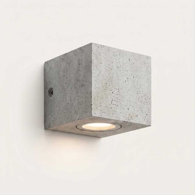 Ilse concrete outdoor wall light lit warm on a soft off-white studio background