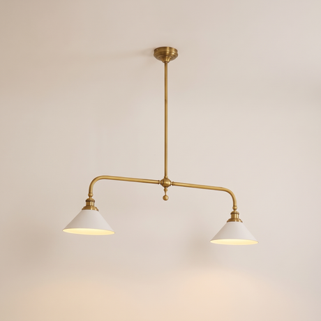 Thetford linear brass pendant lit warm on a soft off-white studio background