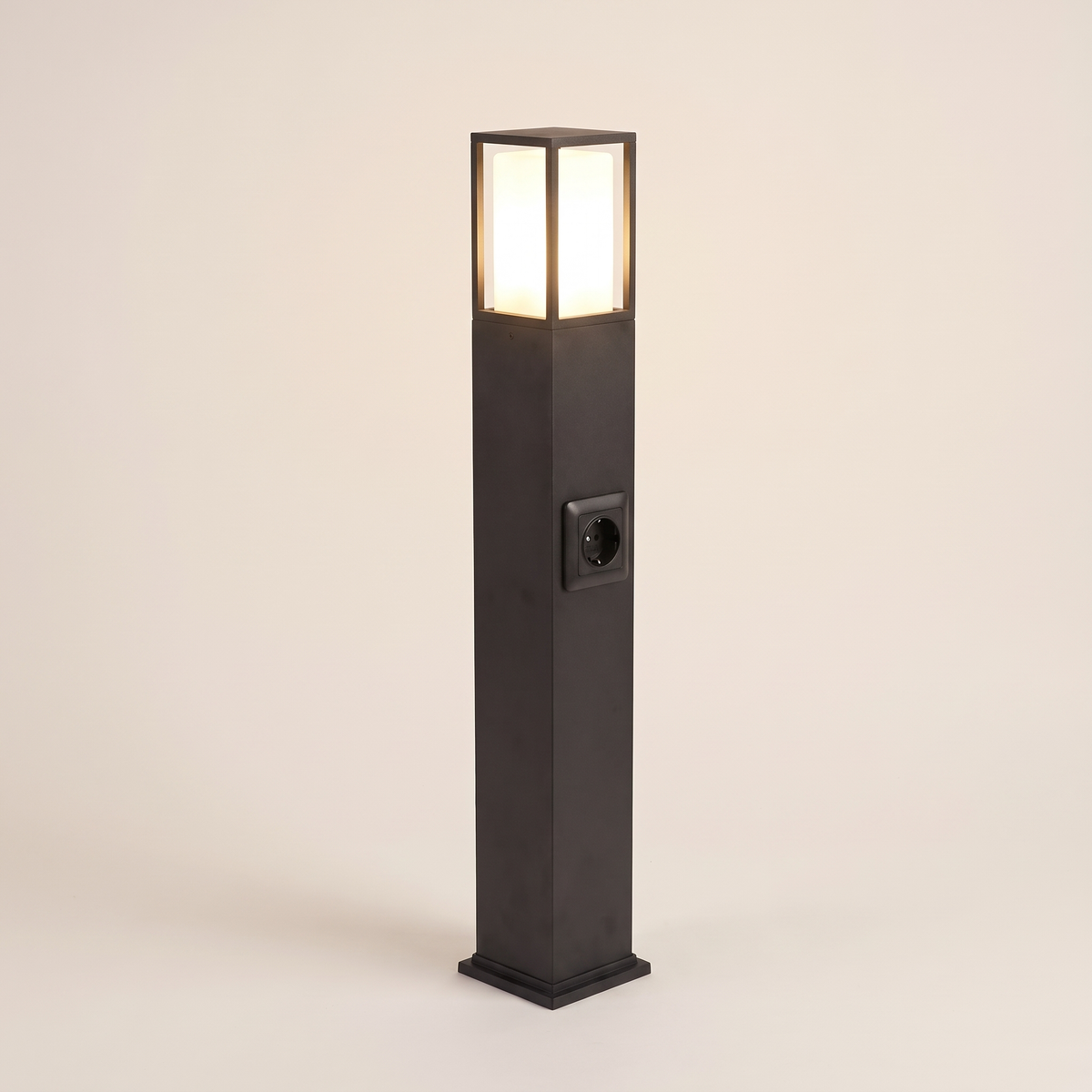 Cairn bollard path light lit warm on a soft off-white studio background