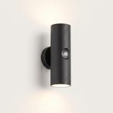 Vega up-and-down outdoor wall light lit warm on a soft off-white studio background