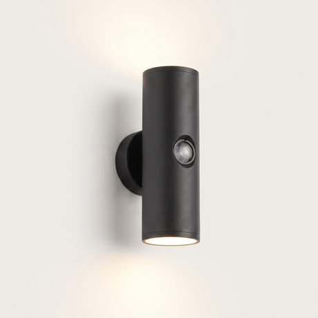 Vega up-and-down outdoor wall light lit warm on a soft off-white studio background